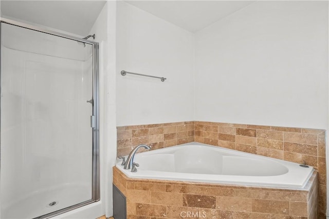 bathroom featuring separate shower and tub