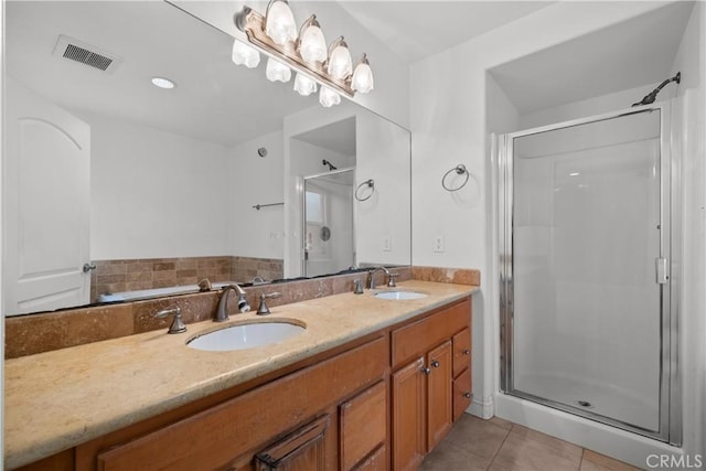 bathroom with tile patterned flooring, vanity, and a shower with door