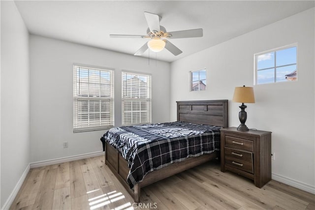 bedroom with light hardwood / wood-style floors and ceiling fan