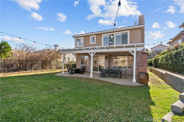 back of property with a yard and a patio area