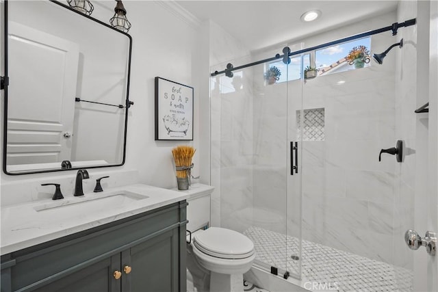 bathroom featuring vanity, toilet, an enclosed shower, and ornamental molding