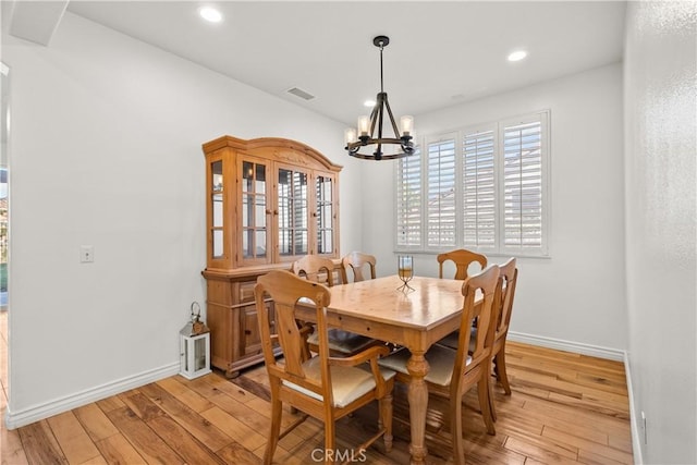 dining room with a chandelier and light hardwood / wood-style floors