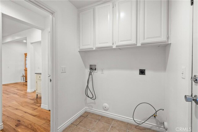 clothes washing area featuring washer hookup, electric dryer hookup, gas dryer hookup, and cabinets