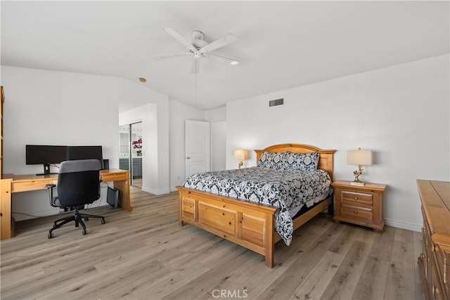 bedroom with ceiling fan, vaulted ceiling, and light hardwood / wood-style flooring