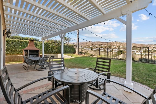 view of patio featuring a pergola and an outdoor fireplace