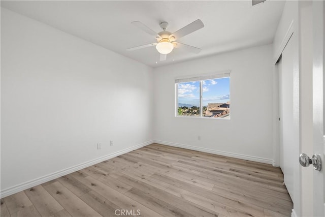 spare room featuring ceiling fan and light hardwood / wood-style floors