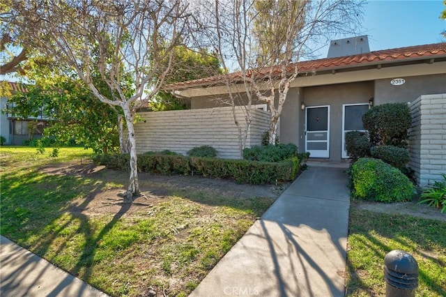 entrance to property with a yard