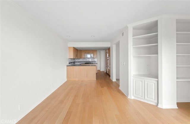 hallway with light hardwood / wood-style floors