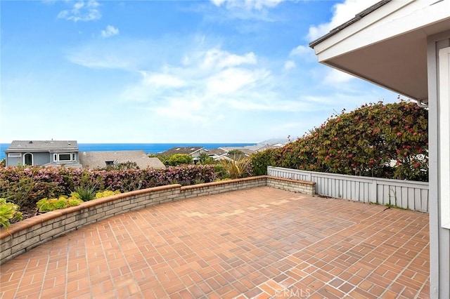 view of patio with a water view