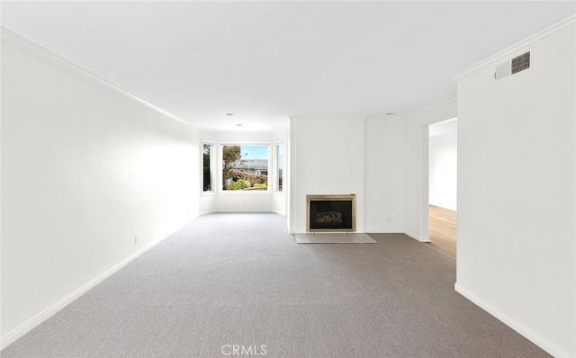 unfurnished living room with carpet floors and crown molding