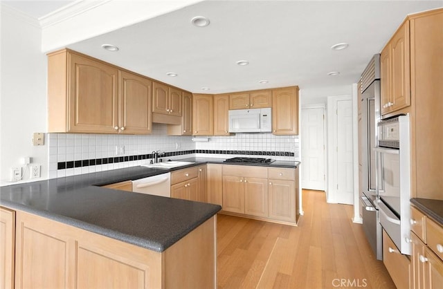 kitchen with sink, light hardwood / wood-style flooring, backsplash, white appliances, and ornamental molding