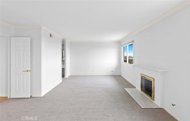 unfurnished living room with crown molding and carpet