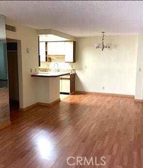 interior space featuring hardwood / wood-style flooring and a chandelier