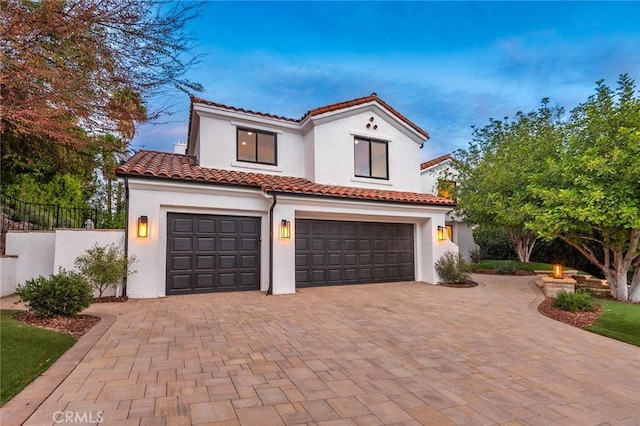 mediterranean / spanish home with a garage