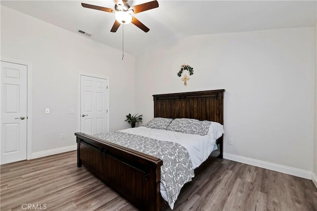 bedroom featuring wood-type flooring, ceiling fan, and lofted ceiling