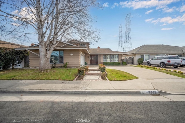 ranch-style house with a front lawn and a garage