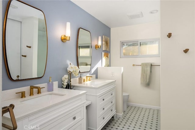 full bathroom with tile patterned floors, toilet, a sink, baseboards, and two vanities