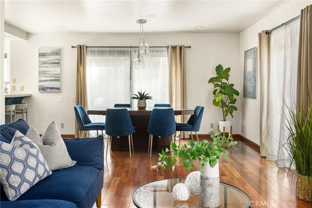 living area with hardwood / wood-style floors and baseboards