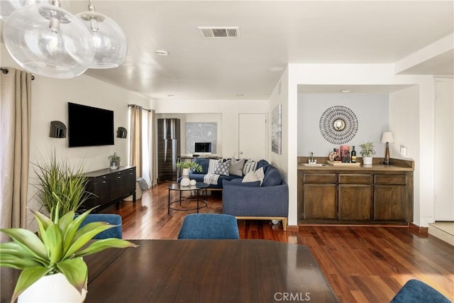 living room featuring dark hardwood / wood-style flooring and sink