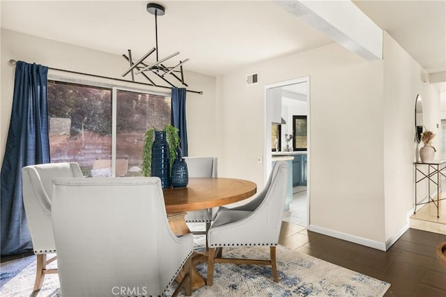 dining space with tile patterned floors, baseboards, visible vents, and an inviting chandelier