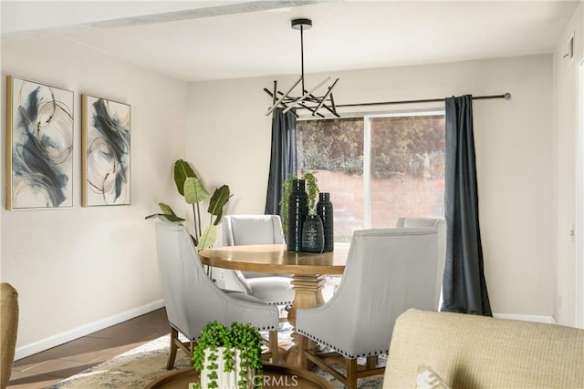 dining space with a chandelier, a wealth of natural light, and baseboards