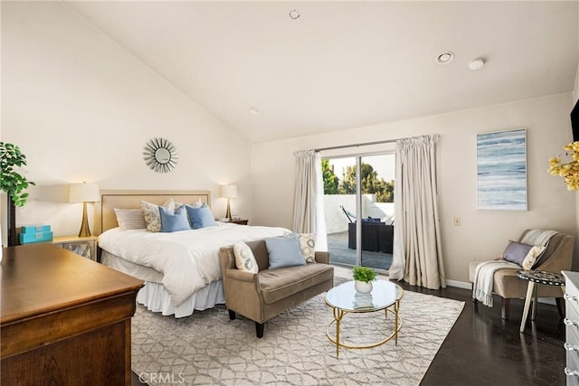 bedroom featuring access to exterior, light hardwood / wood-style floors, and vaulted ceiling