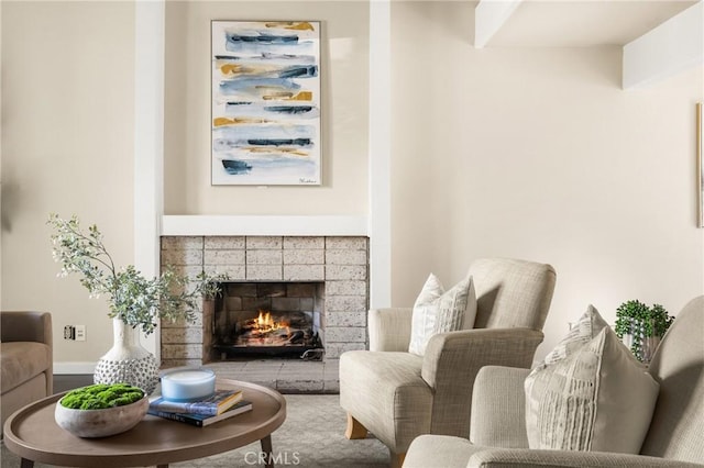 living area with a tiled fireplace