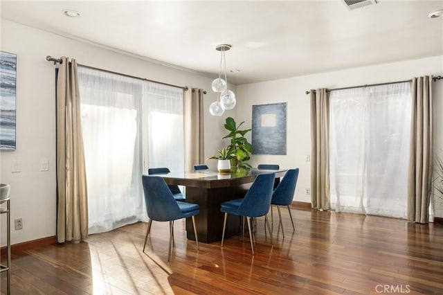 dining area featuring dark wood-type flooring