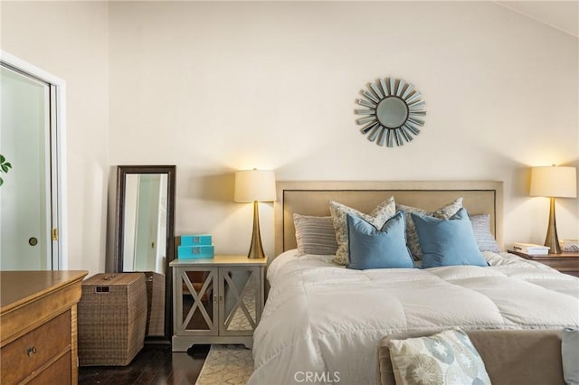 bedroom with dark wood-type flooring