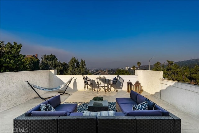 patio terrace at dusk with an outdoor hangout area and outdoor dining area