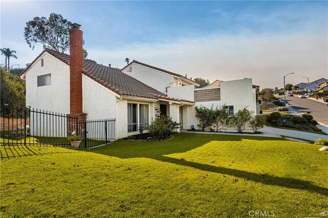 rear view of property featuring a yard