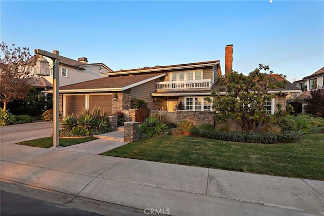 view of front of house with a garage and a front lawn