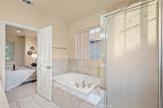 bathroom with tile patterned flooring and separate shower and tub