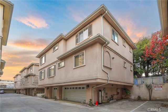 outdoor building at dusk featuring a garage