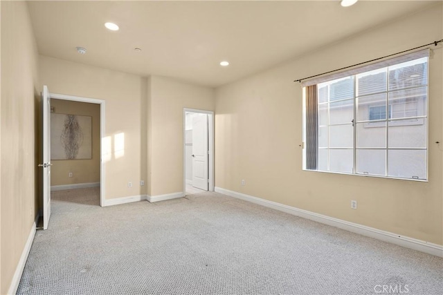 unfurnished bedroom with light colored carpet