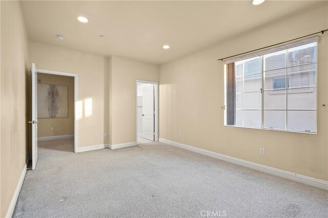 unfurnished bedroom featuring light colored carpet