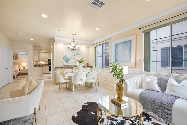 living room featuring an inviting chandelier, crown molding, and light tile patterned floors