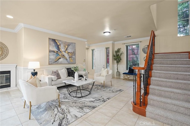 living room featuring light tile patterned floors and ornamental molding