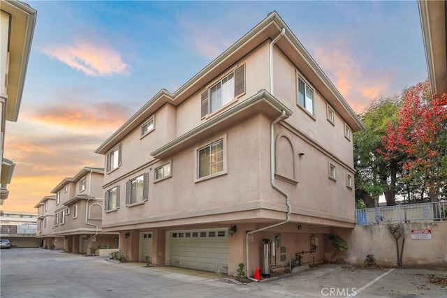 outdoor building at dusk featuring a garage