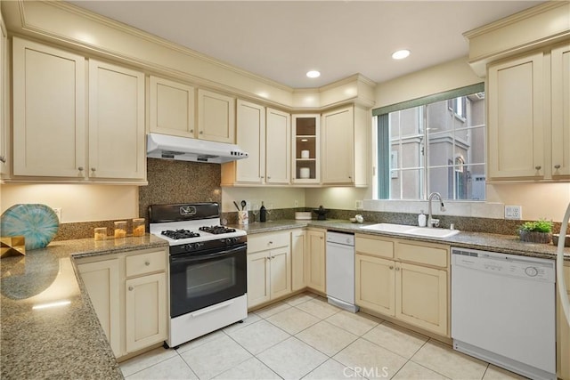 kitchen with white dishwasher, sink, cream cabinets, and gas stove