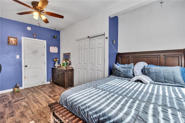 bedroom with a ceiling fan, a closet, baseboards, and wood finished floors