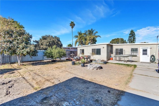 rear view of property featuring a patio area and a fenced backyard