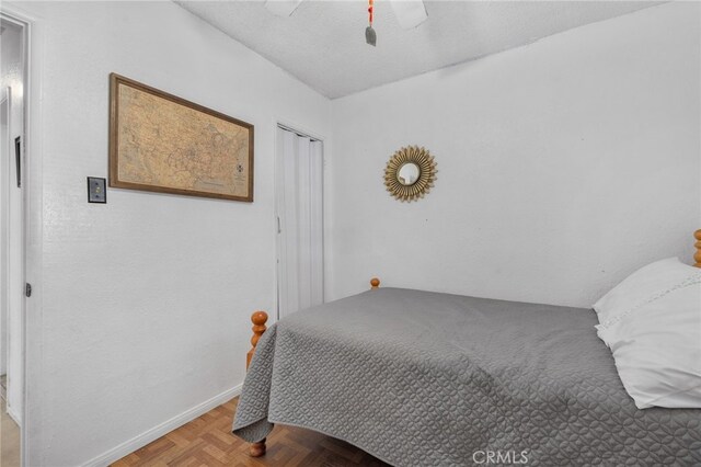 bedroom with ceiling fan and light parquet flooring