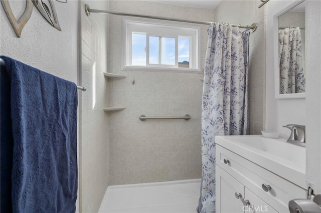 bathroom featuring walk in shower and vanity