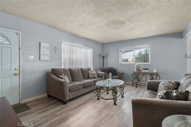 1538 W 15th St, San Bernardino, CA 92411 - living area with baseboards, a textured ceiling, and wood finished floors