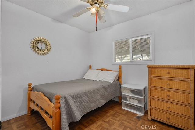 bedroom with dark parquet flooring and ceiling fan