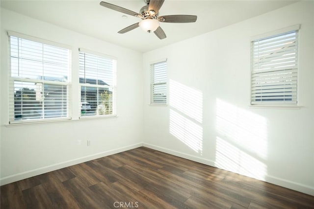 spare room with ceiling fan and dark hardwood / wood-style flooring