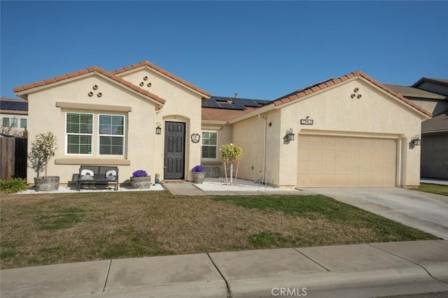 mediterranean / spanish-style home featuring a front yard, solar panels, and a garage