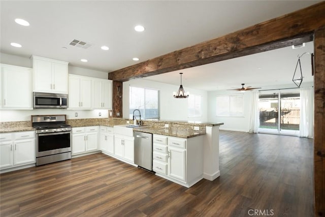 kitchen featuring appliances with stainless steel finishes, decorative light fixtures, white cabinetry, kitchen peninsula, and beam ceiling