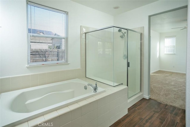 bathroom featuring ceiling fan and separate shower and tub